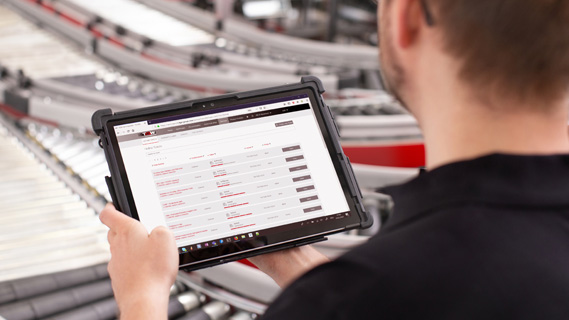 Man operating the warehouse management system on a tablet