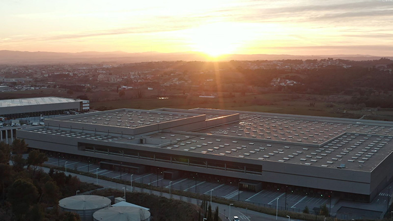 Overview of the Mango distribution center with the sun going down in the background