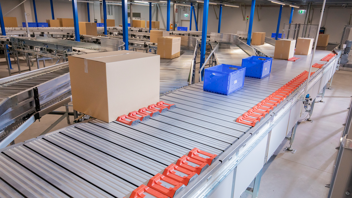 Cartons and totes traveling down the TGW Logistics Natrix sorting system where the goods will be sorted and diverted to the next working area