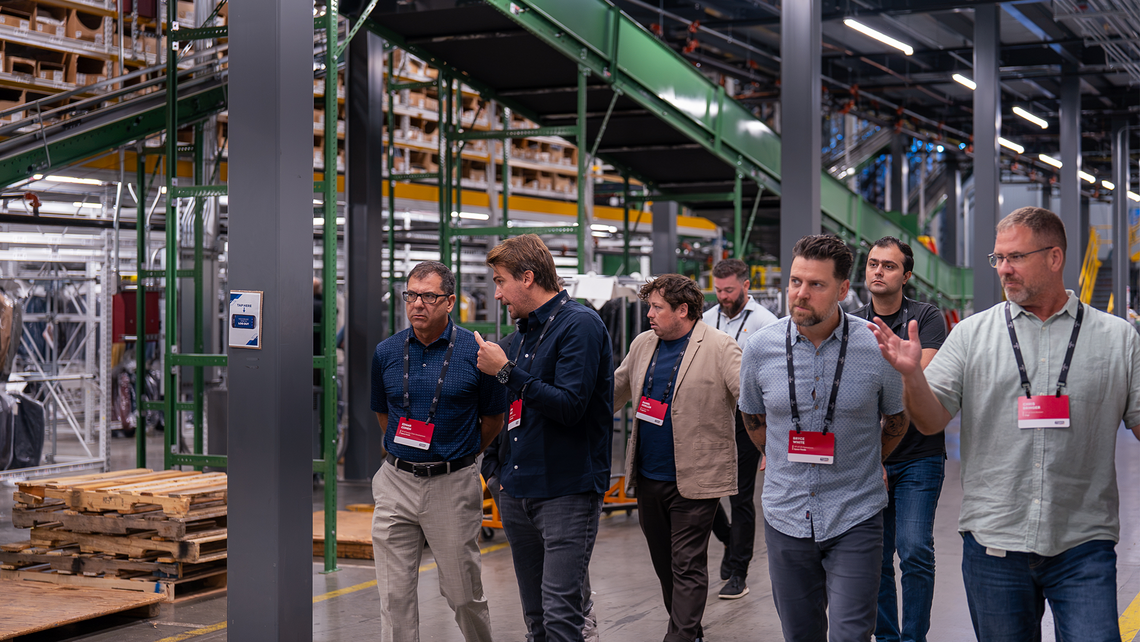 Campfire Talk attendees walking through the Gap automated distribution center