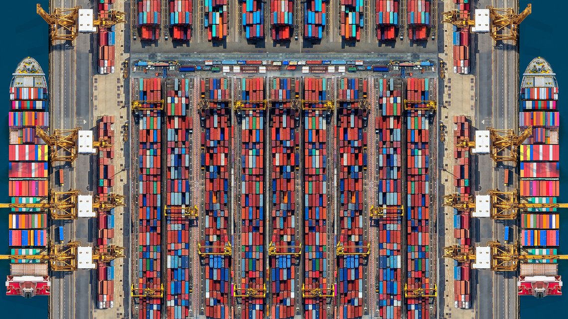 An overview of a lot of shipping containers on a dock
