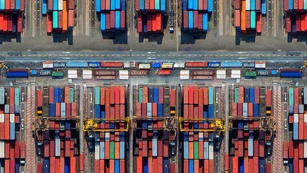 An overview of a lot of shipping containers on a dock