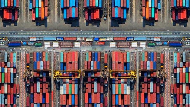 An overview of a lot of shipping containers on a dock