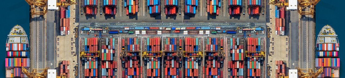An overview of a lot of shipping containers on a dock