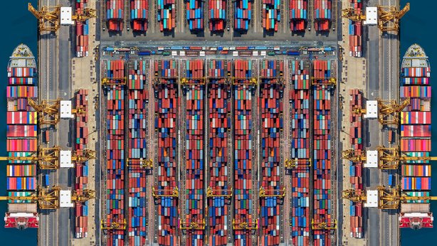 An overview of a lot of shipping containers on a dock