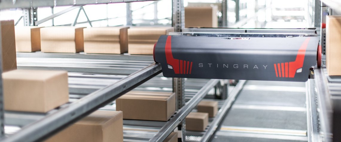 Latest model of the TGW Stingray shuttle moving through the shuttle aisle