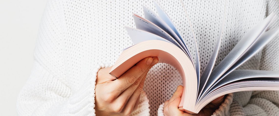 A woman leafing through a book