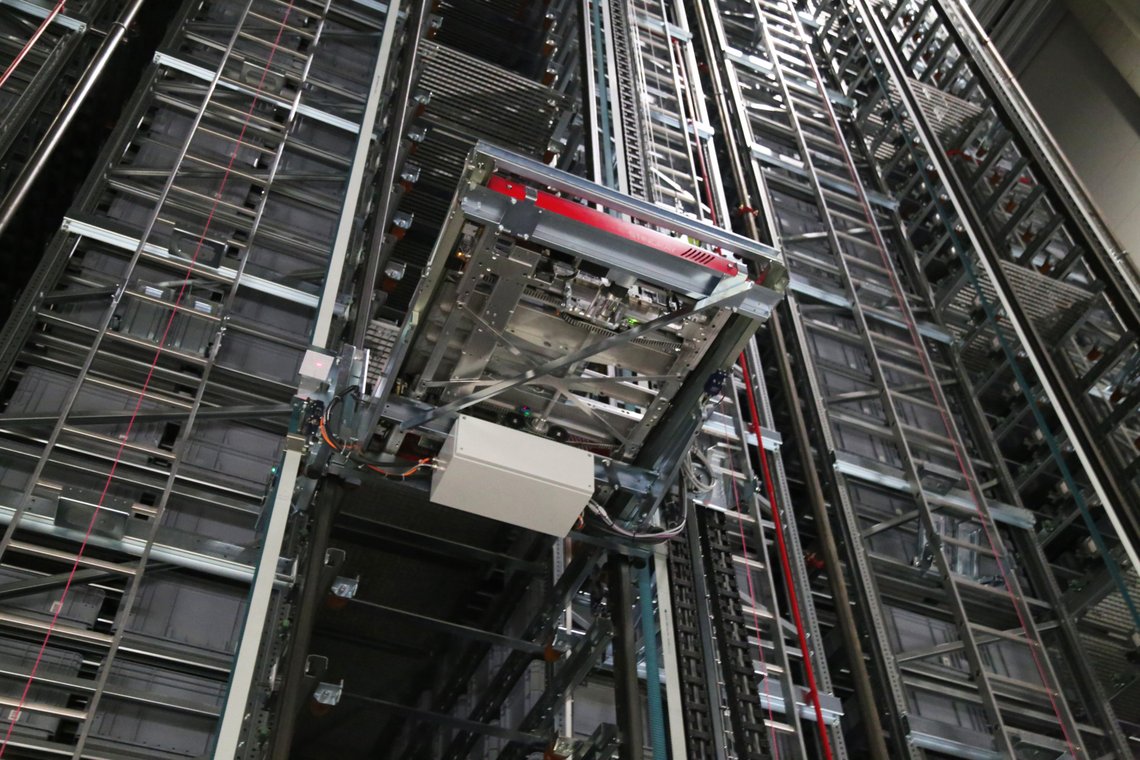 TGW's shuttle lift in front of rackings at Bileko Car Parts