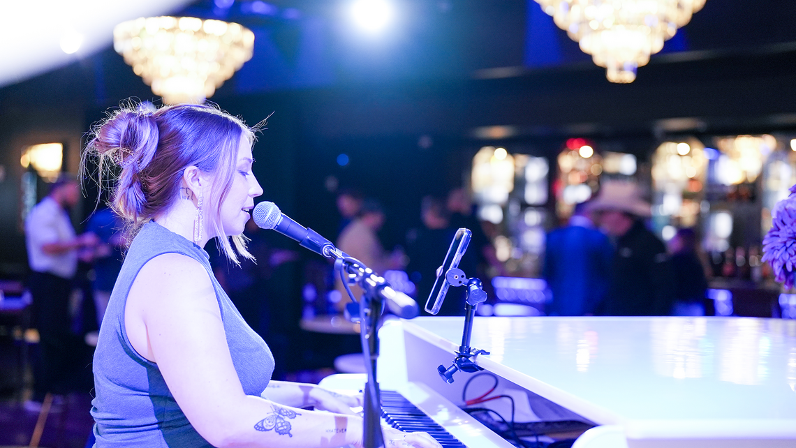 Woman at piano singing in the private dinner lounge