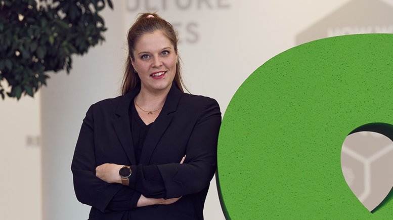 Global Marketing & Communications Manager Ingrid Gogl posing with the &-sign