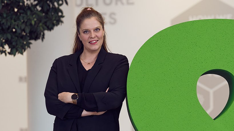Global Marketing & Communications Manager Ingrid Gogl posing with the &-sign