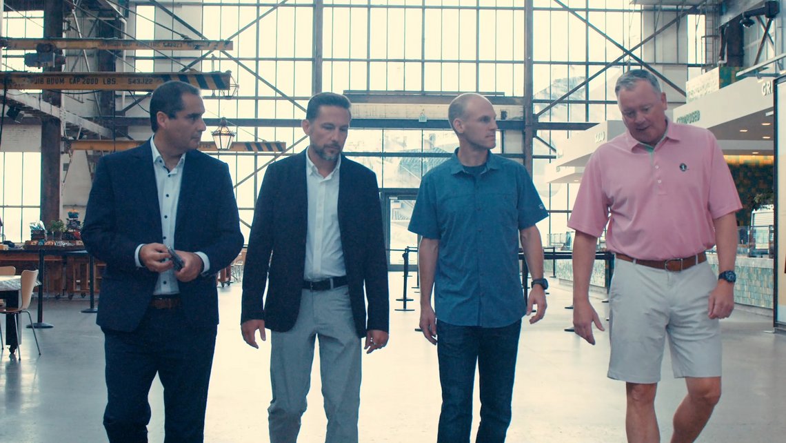 Executives from TGW Logistics and URBN walking through the URBN headquarters