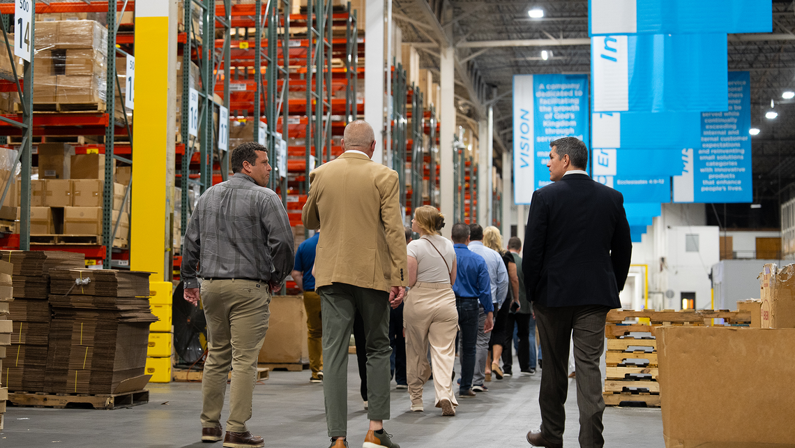 Attendees of Campfire Talk at Jasco walking through the warehouse