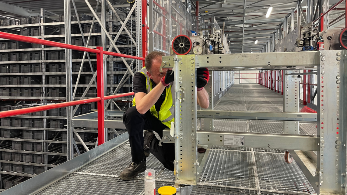 Lifetime service team member working on a TGW Logistics Stingray shuttle