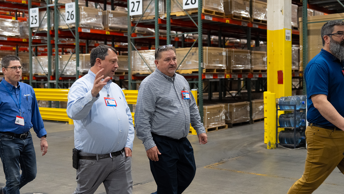 Attendees of Campfire Talk at Jasco walking through the warehouse