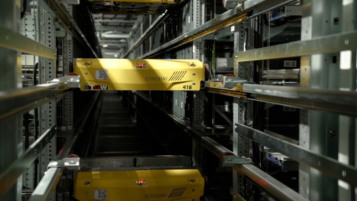 Two TGW Logistics' Stingray shuttles colored yellow based on customer request
