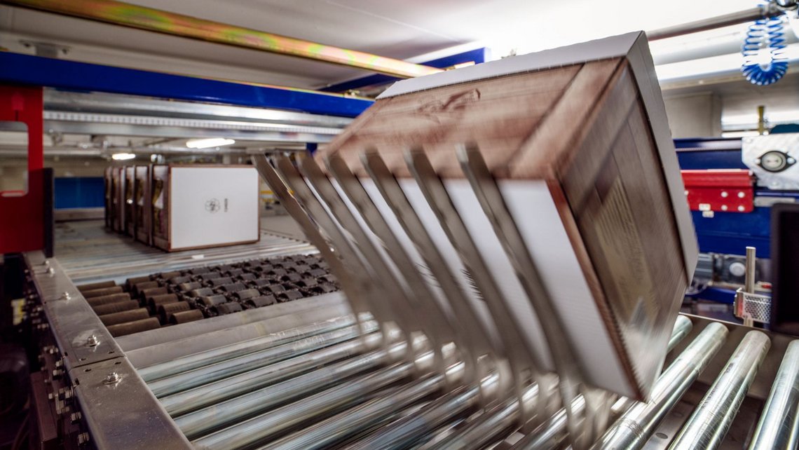 A box of goods is transported further on the Flip conveyor belt