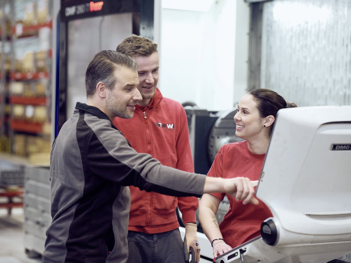 A man and a woman talking in a warehouse area