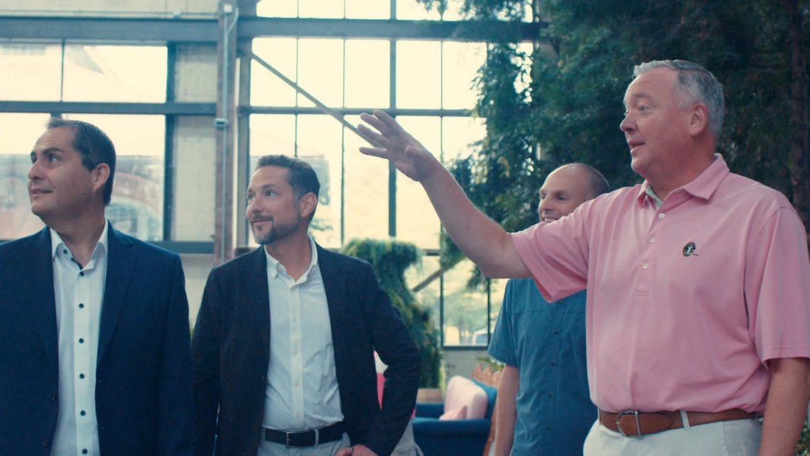 Executives from TGW Logistics and URBN walking through the URBN headquarters